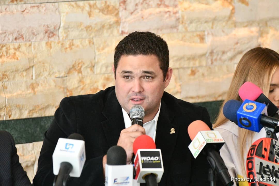 Frank Wadskier speaking in front of several microphones at a press conference