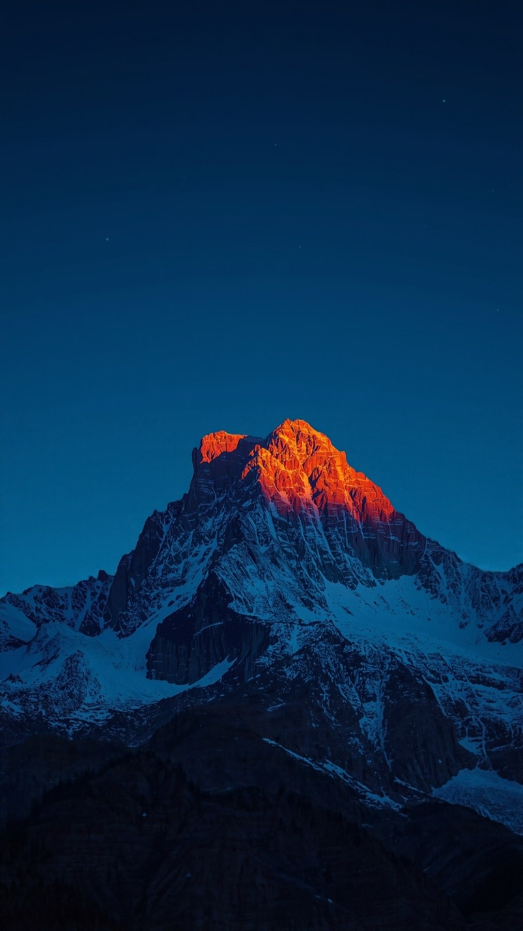 AI-generated illustration: a snow-dusted mountain peak glowing orange at first light under a deep blue sky.
